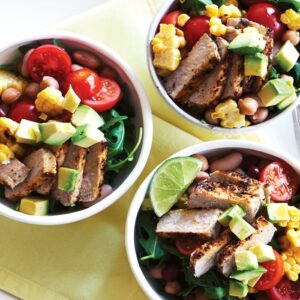 Piri piri pork with grilled corn, avocado and rocket salad
