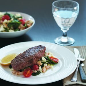 Steak with warm bean and spinach salad